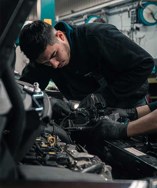 Mechanic working on car engine