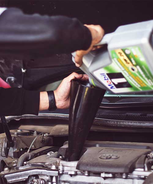 Technician performing oil change